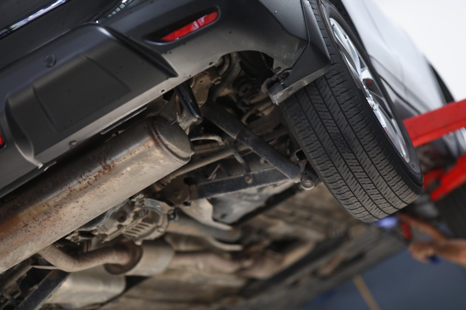 car-lifted-maintenance-service-checkup-undercarriage-automobile-bottom-view